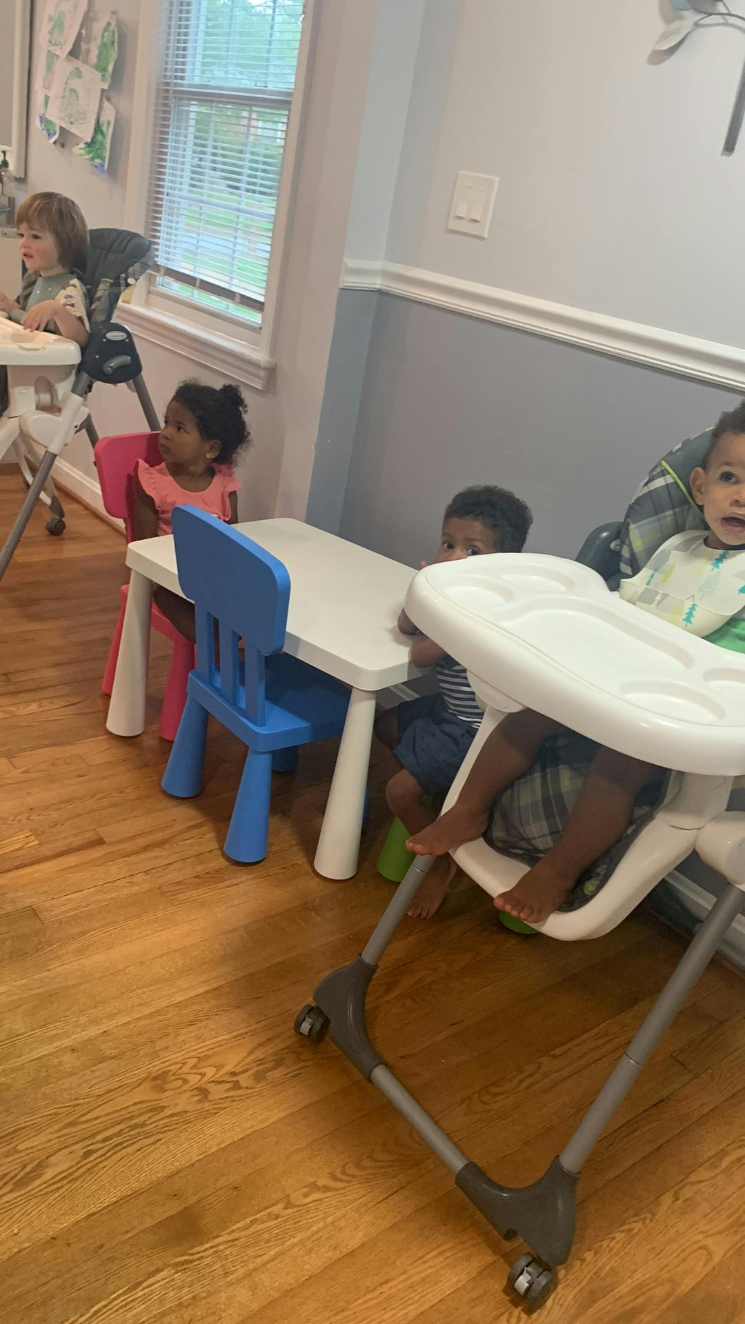 Children sitting at tables and in high chairs