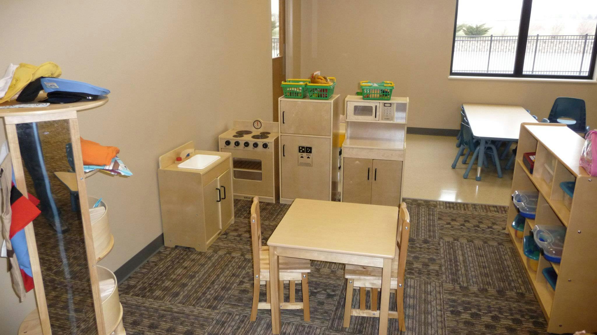 Playroom with child-sized furniture and play kitchen