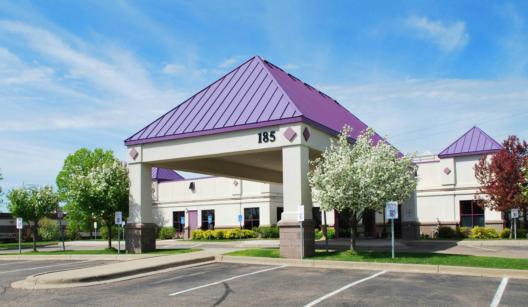 Building with purple roof and covered entrance labeled 185