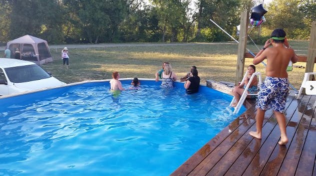 People in and around a swimming pool