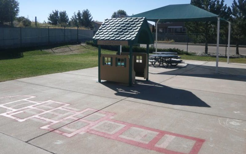Playhouse and hopscotch outline on pavement