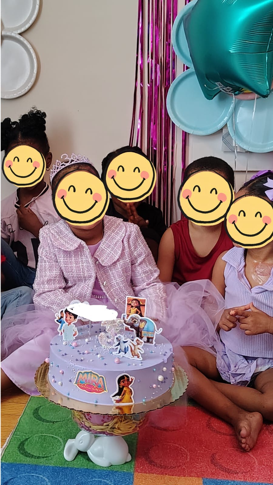 Group of children sitting around a Mira Royal Detective birthday cake