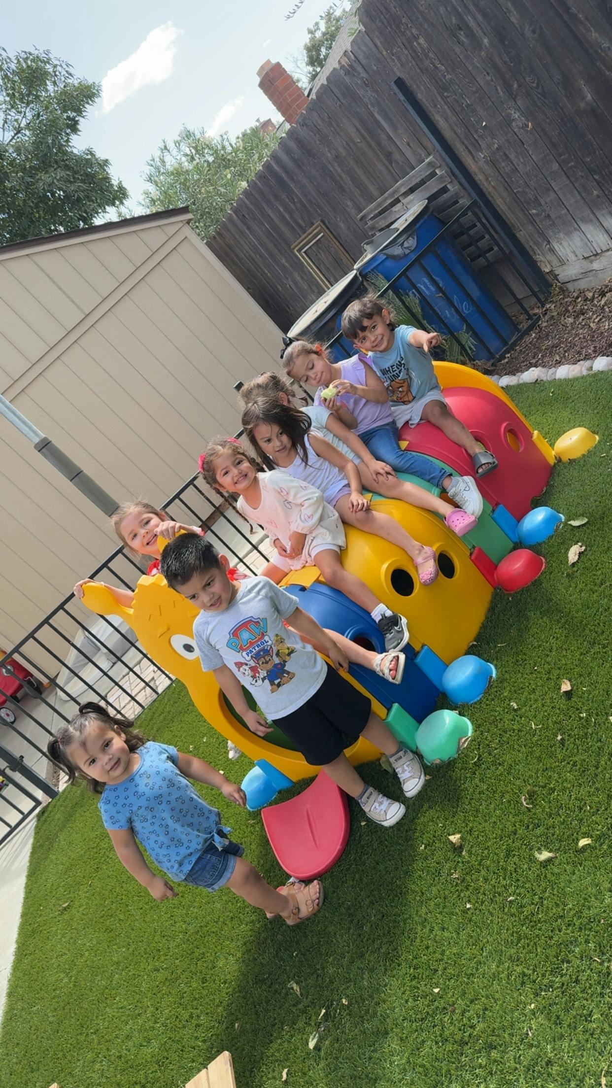 Children playing on a colorful outdoor toy