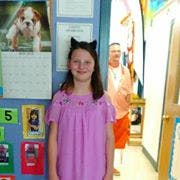Child wearing cat ears standing in a doorway