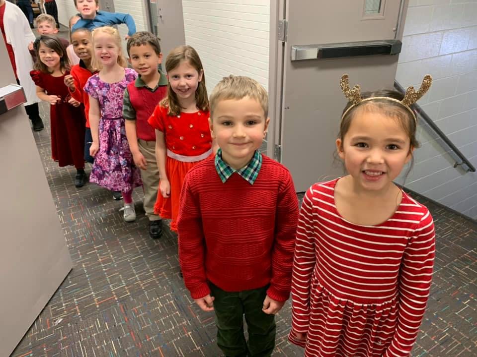 Line of children standing in a hallway