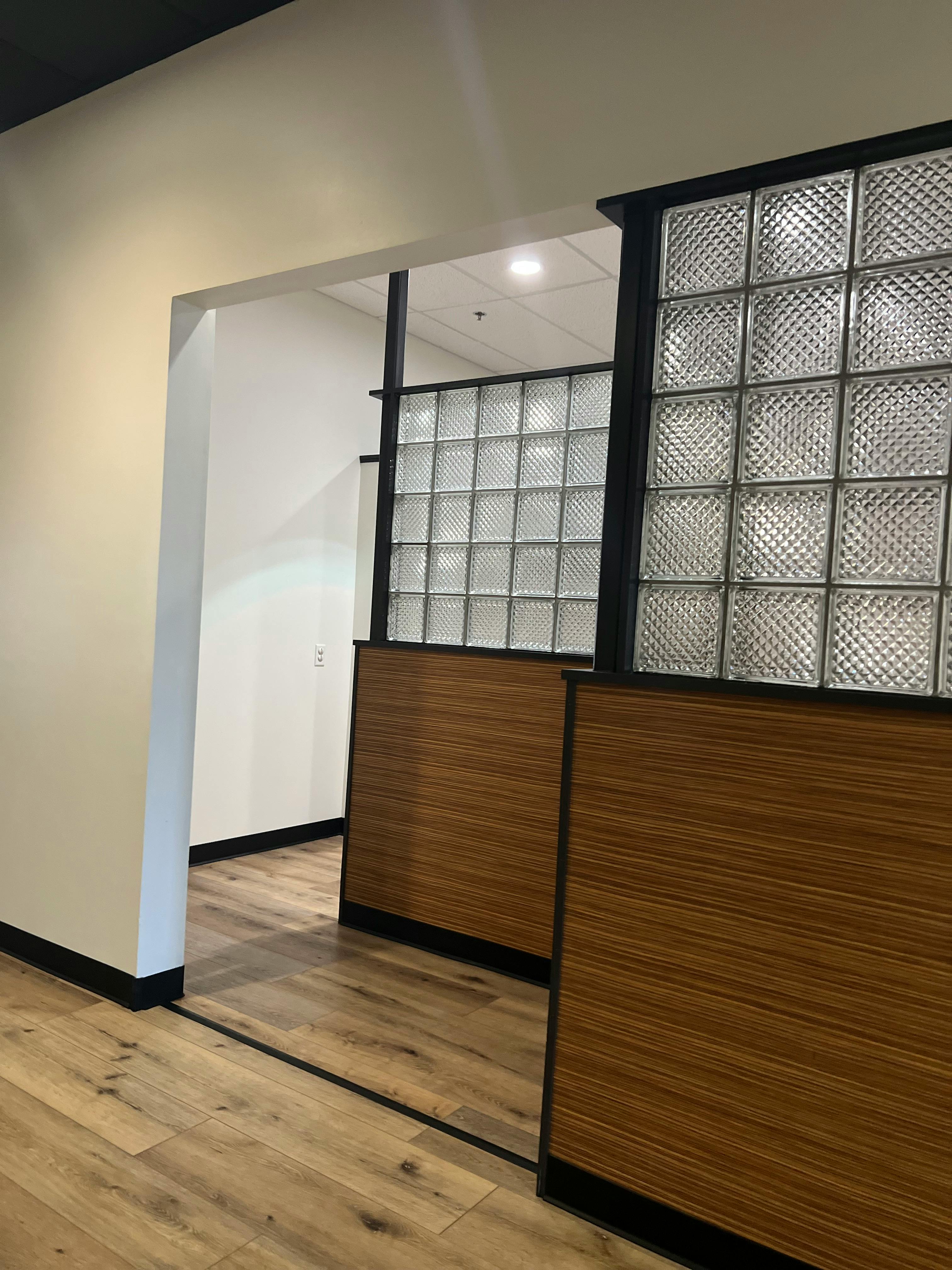 Glass block wall with wood paneling