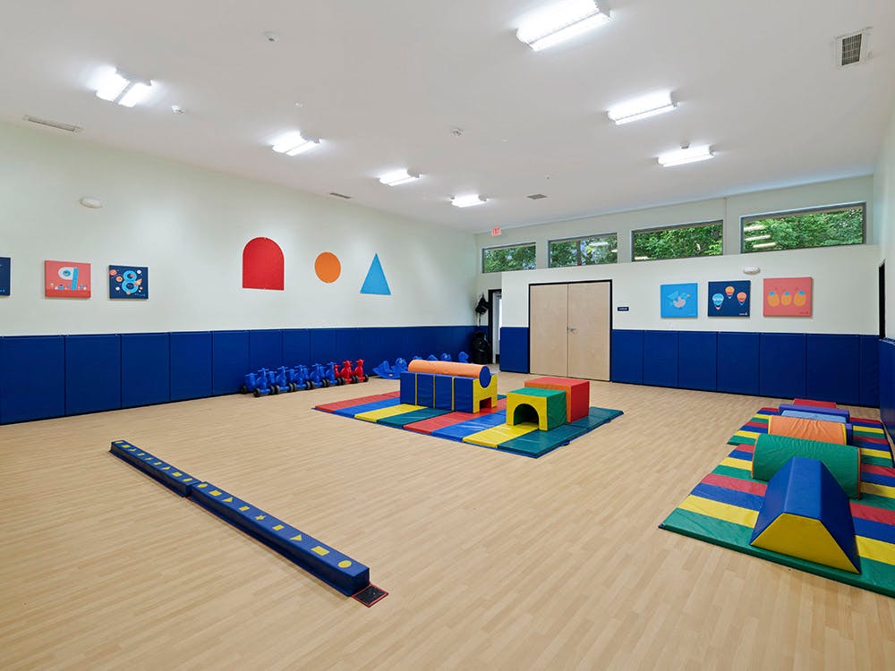 Empty children's playroom with soft play equipment and shapes on the wall