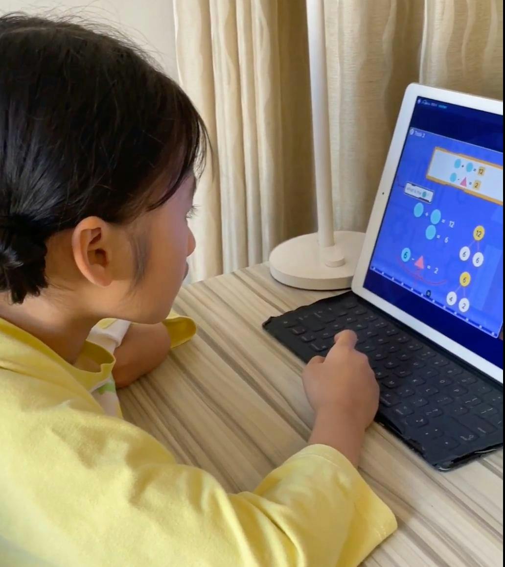 Child using a tablet for an educational math activity