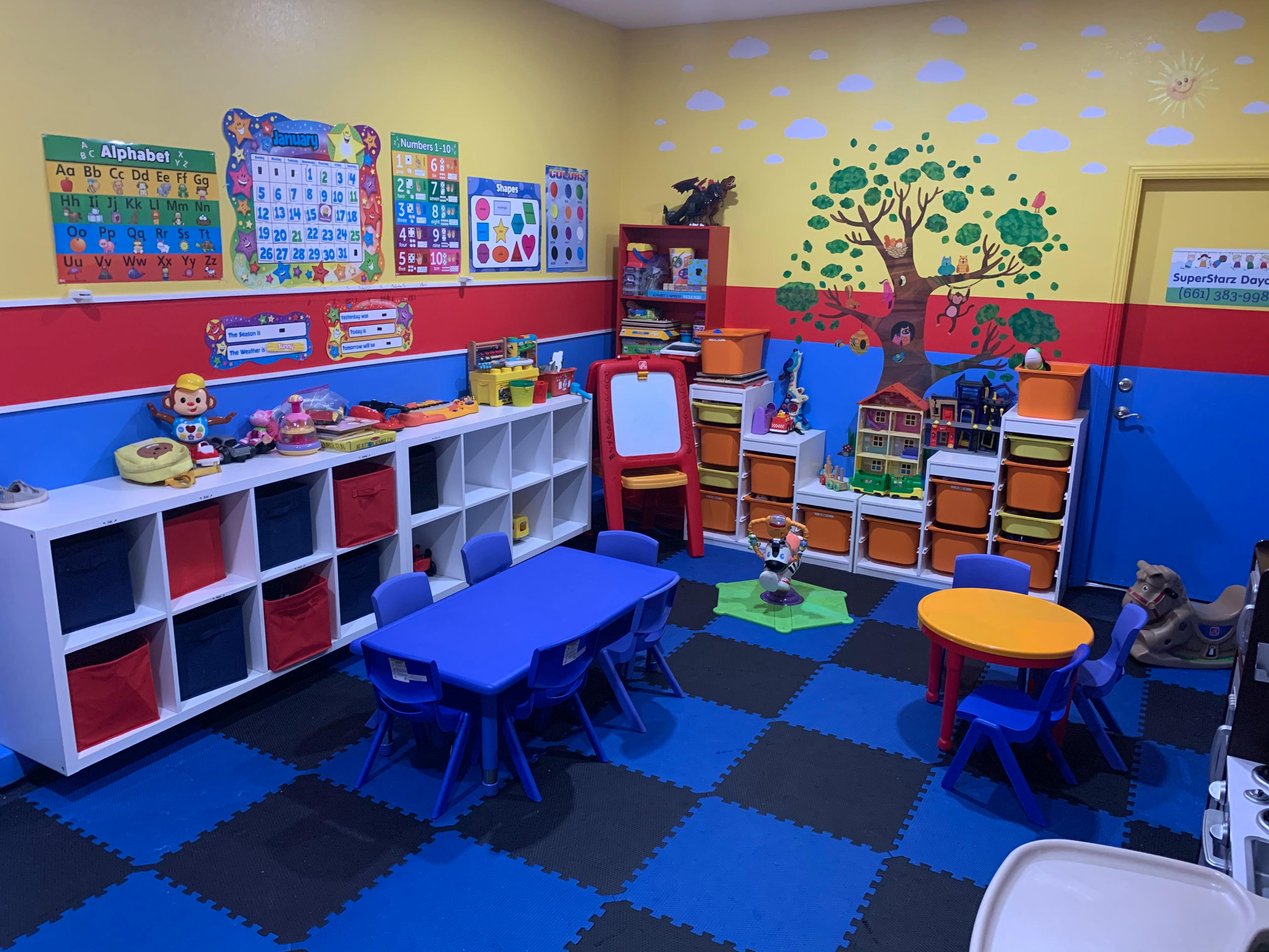 Colorful classroom with small tables and chairs, storage shelves, and wall decorations