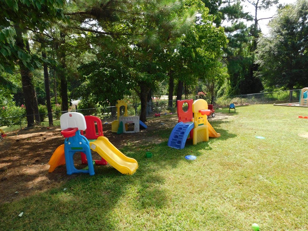 Playground with multiple colorful slides and play structures on grass