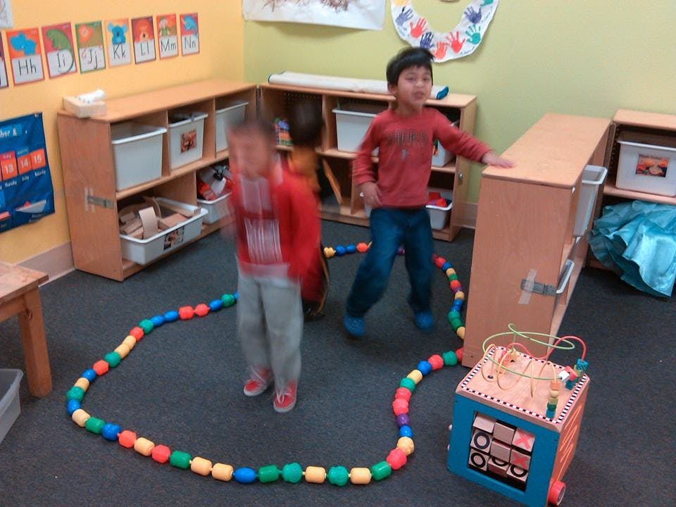 Two children playing in a classroom