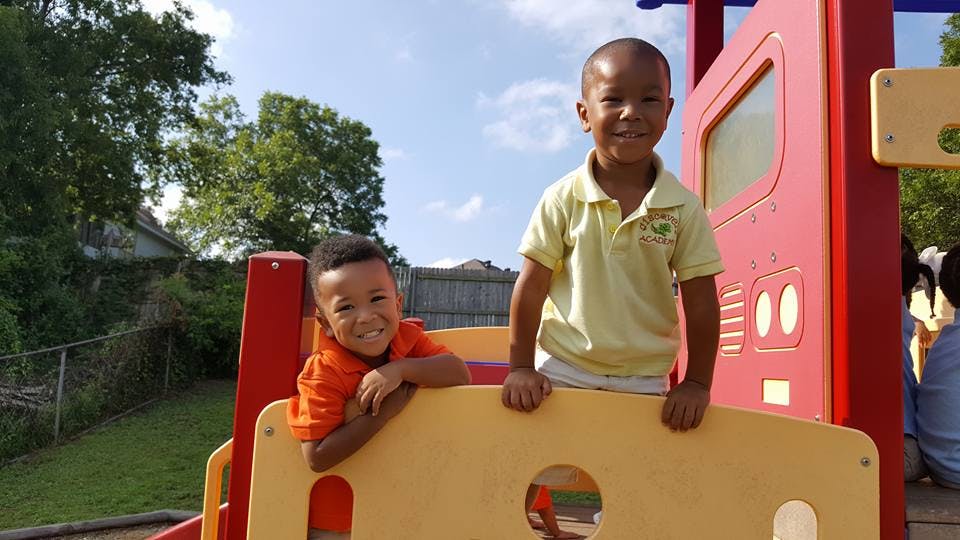 Two children on a playground structure