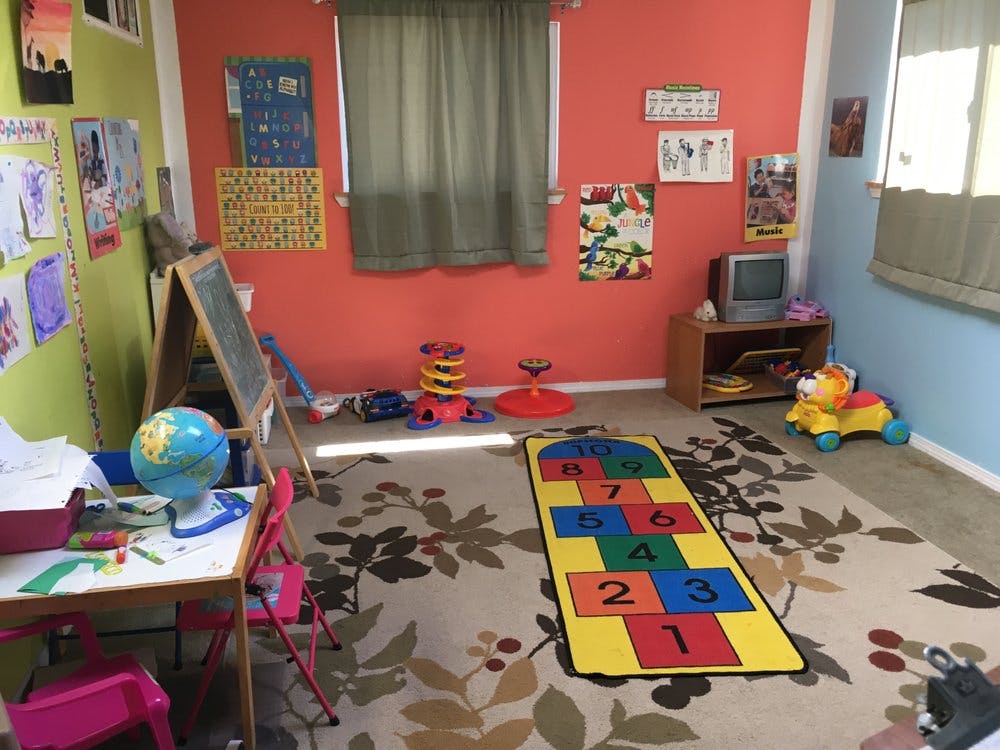 Playroom with a hopscotch mat on the floor and various toys