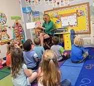 Person reading to children in a classroom