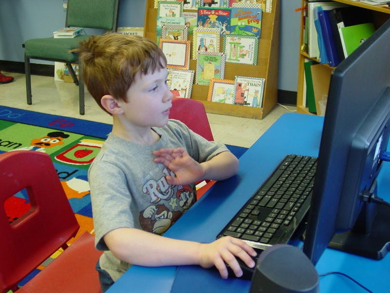 Child using a computer in a classroom