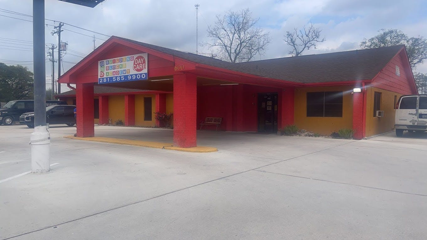 Red and yellow building with a covered entrance