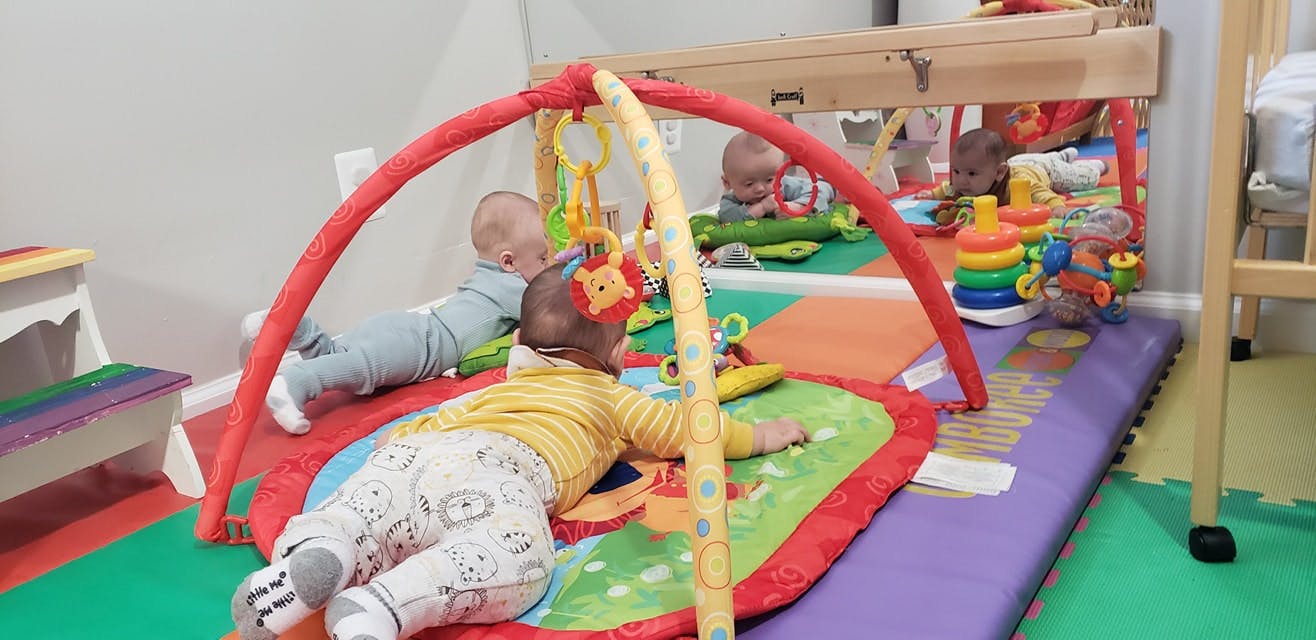 Two children playing on activity mats