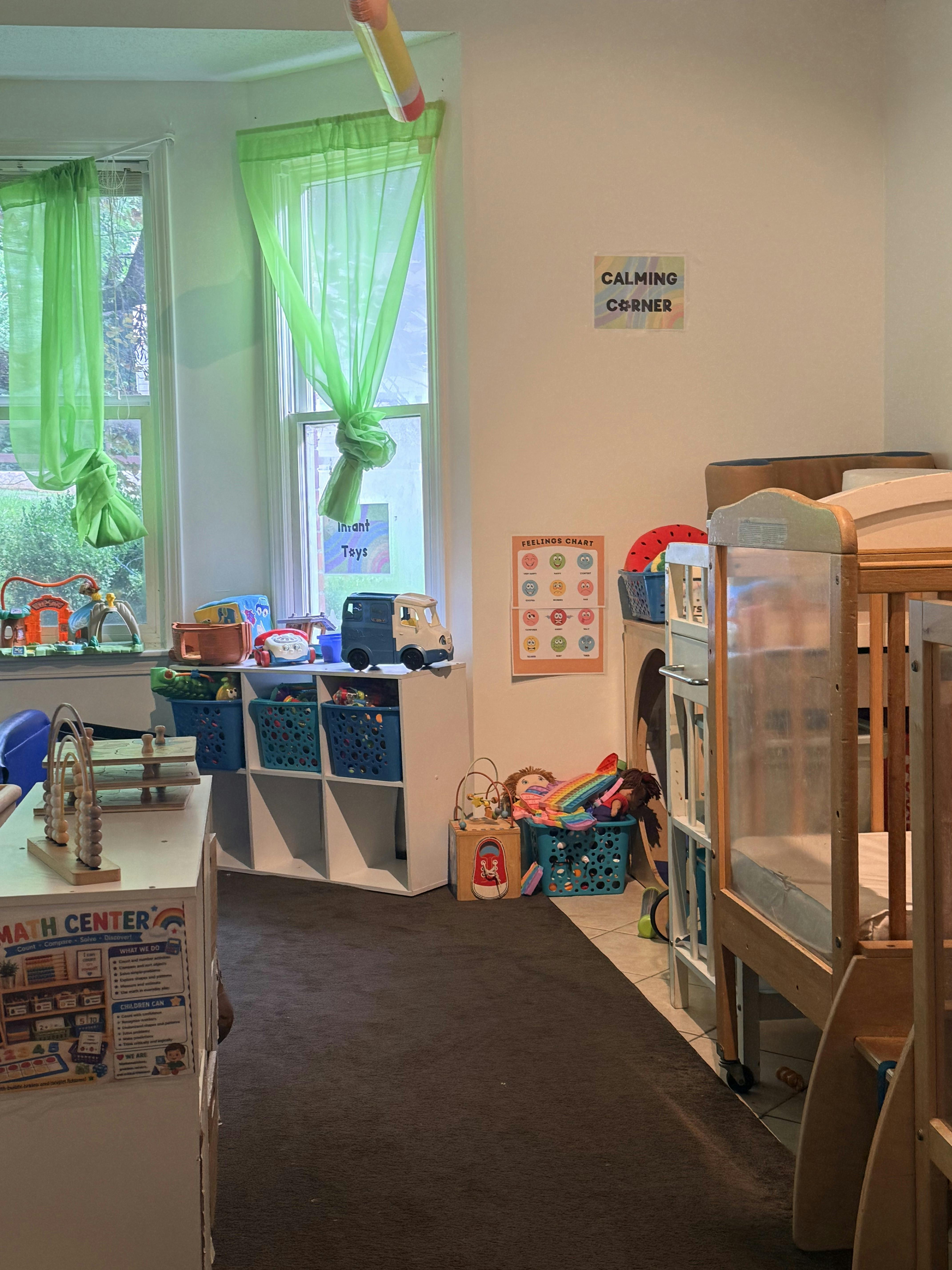 A playroom with toy bins, a feelings chart, and a calming corner sign