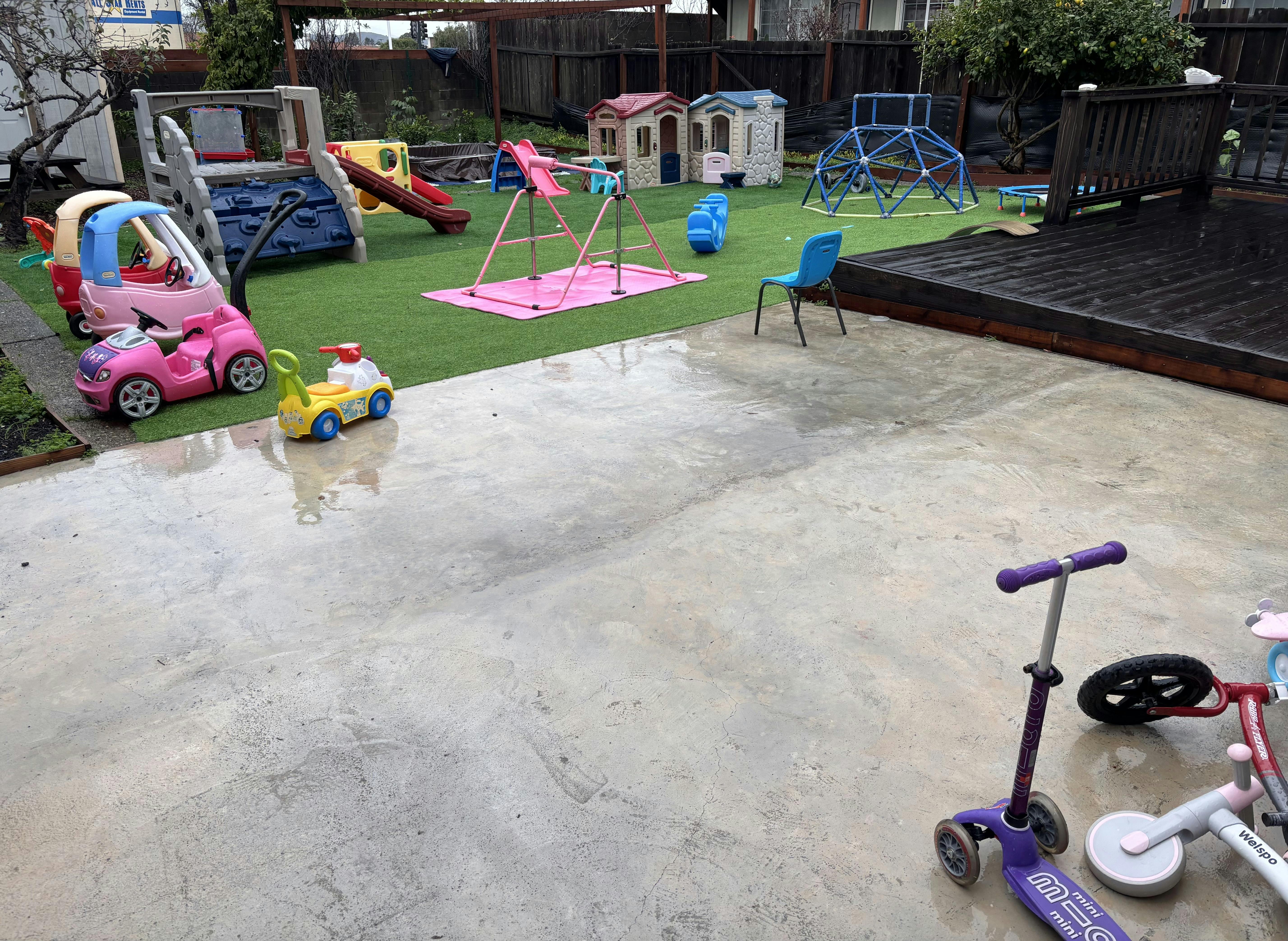 Backyard play area with artificial grass and toys