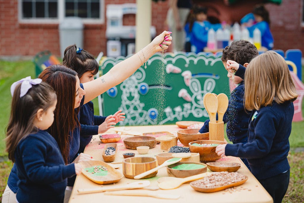 Adult and children at a table with bowls and spoons