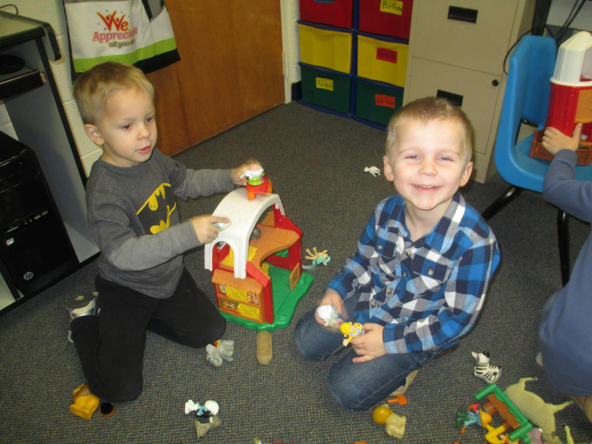 Two children playing with toys on the floor