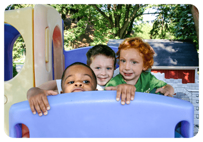 Three children on a playground structure