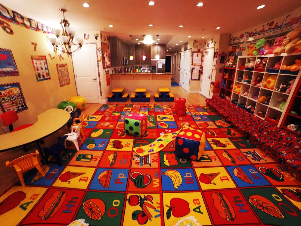 Playroom with colorful alphabet mat and toys