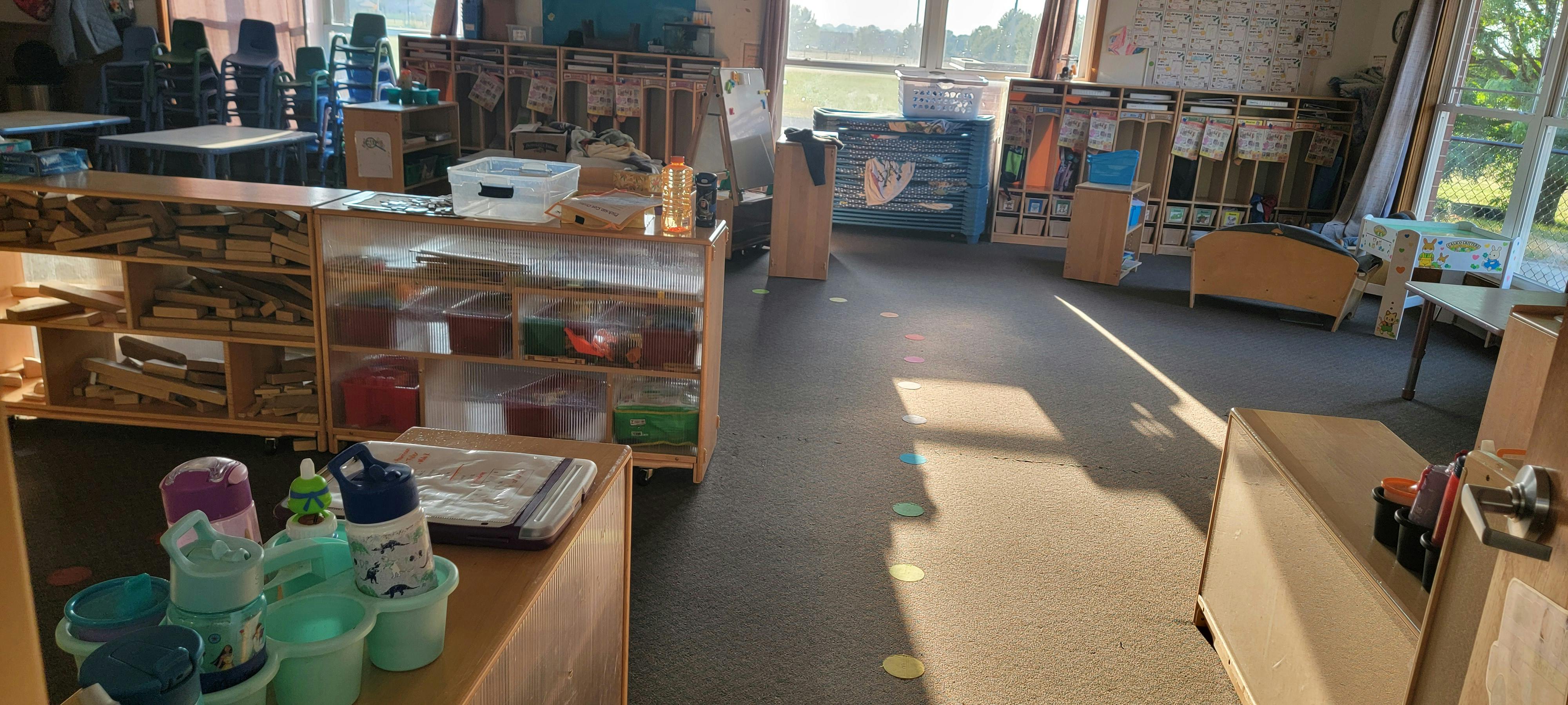 Empty classroom with wooden shelves and sunlight on the floor