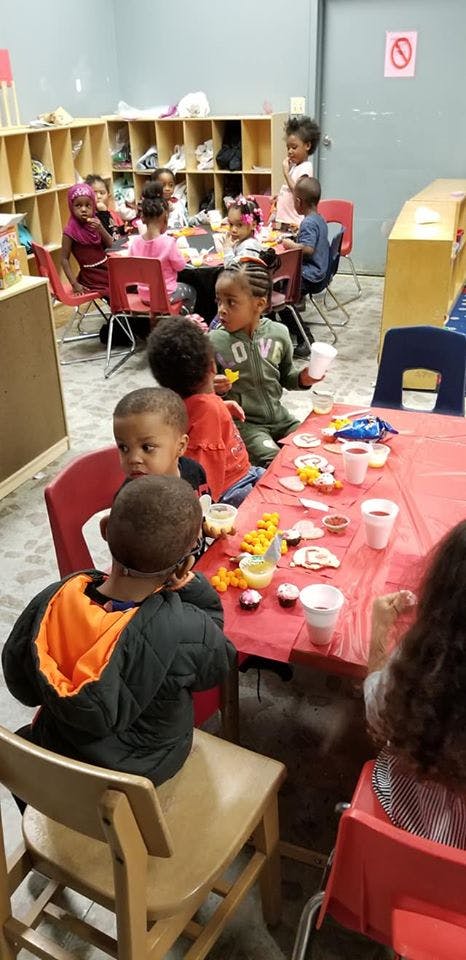 Children sitting at tables in a classroom