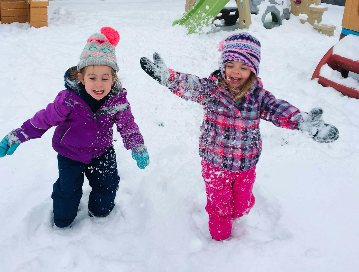 Two children playing in the snow
