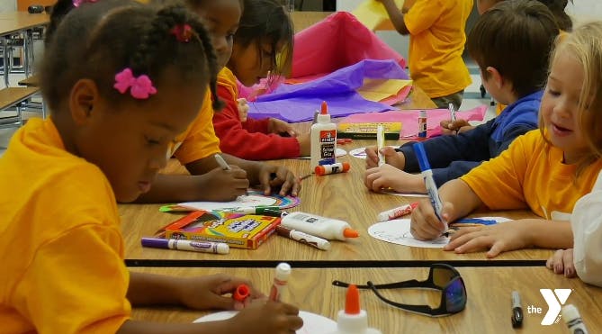 Children doing crafts at a table
