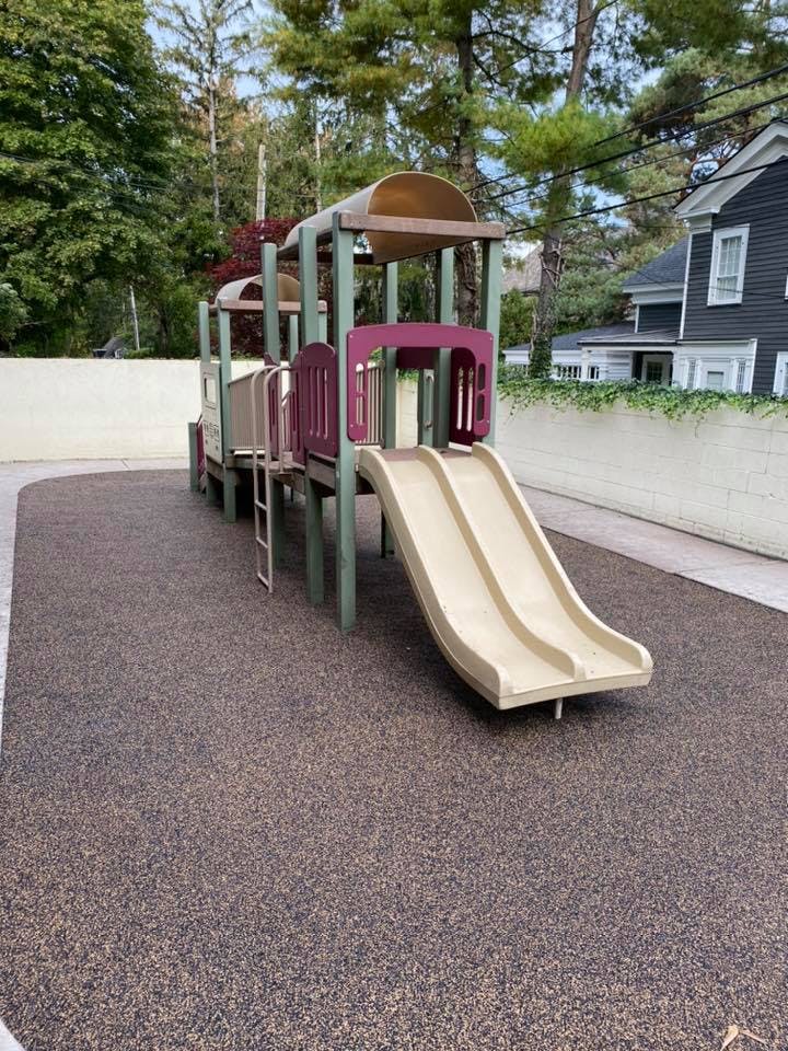 Playground structure with slides and climbing elements