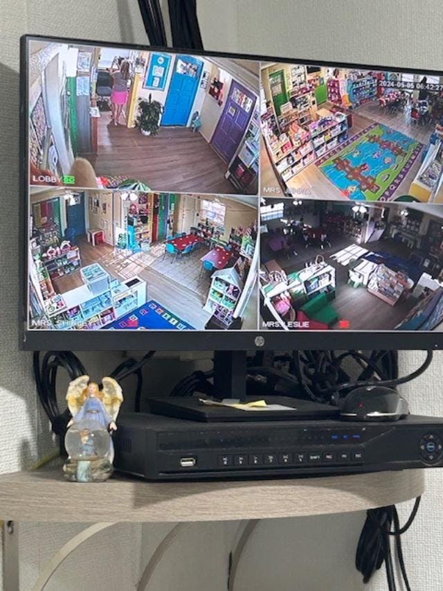 Security monitor displaying four camera feeds of different rooms