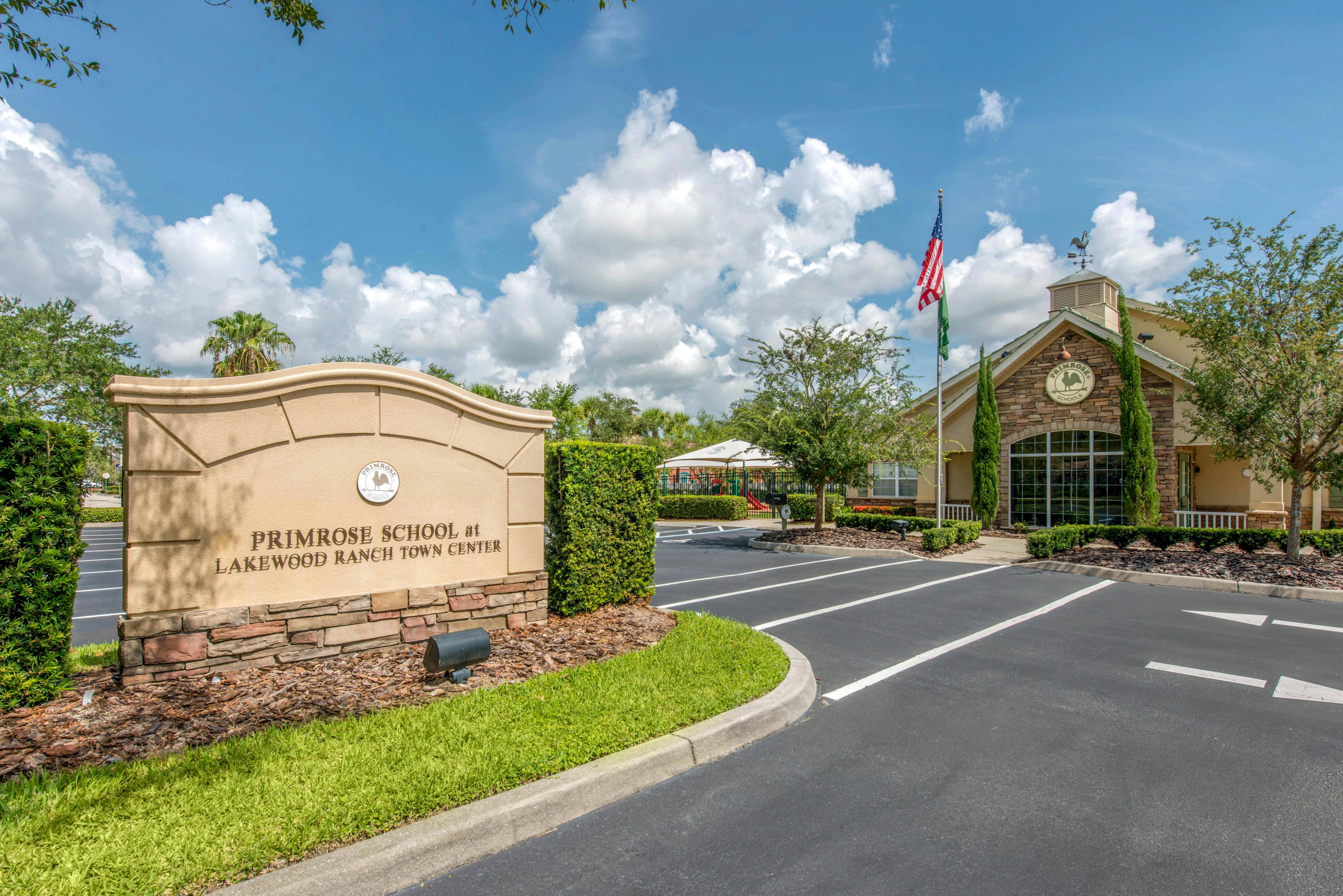 Sign for Primrose School at Lakewood Ranch Town Center with building in background