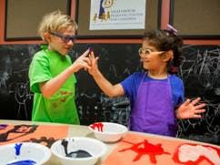 Two children painting in a classroom