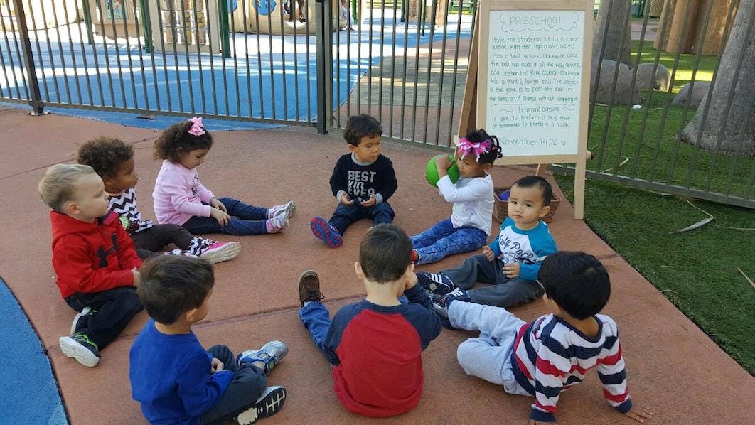 Group of children sitting in a circle outdoors