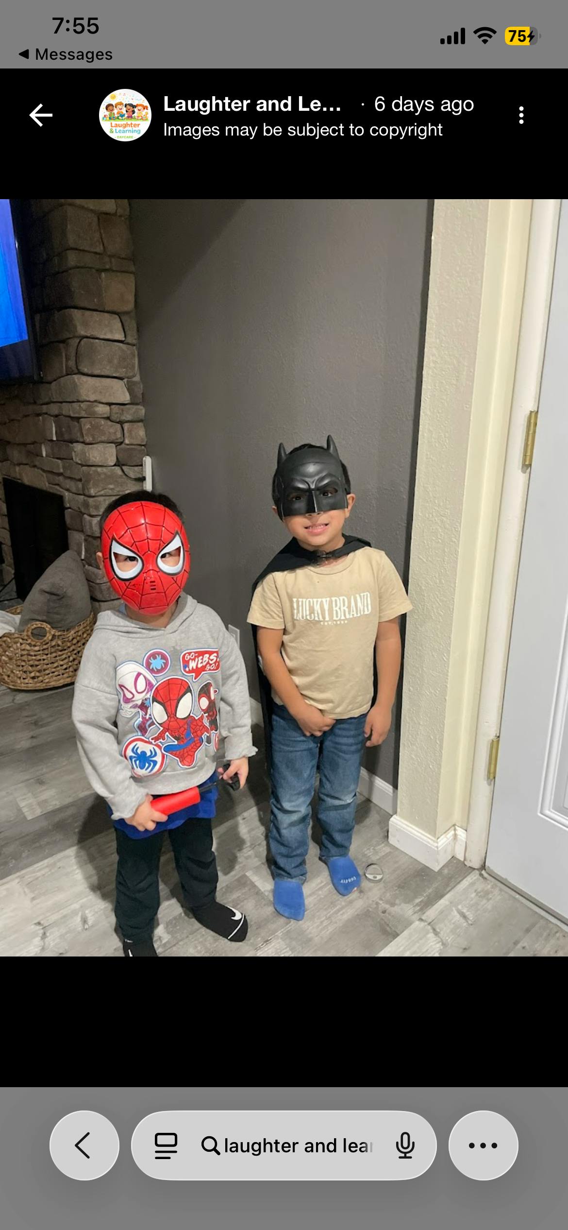 Two children wearing Spider-Man and Batman masks