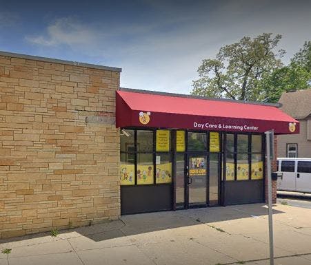 Building with a red awning that reads "Day Care & Learning Center"