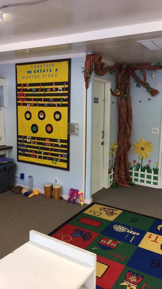 Classroom with a music-themed bulletin board and a tree decoration
