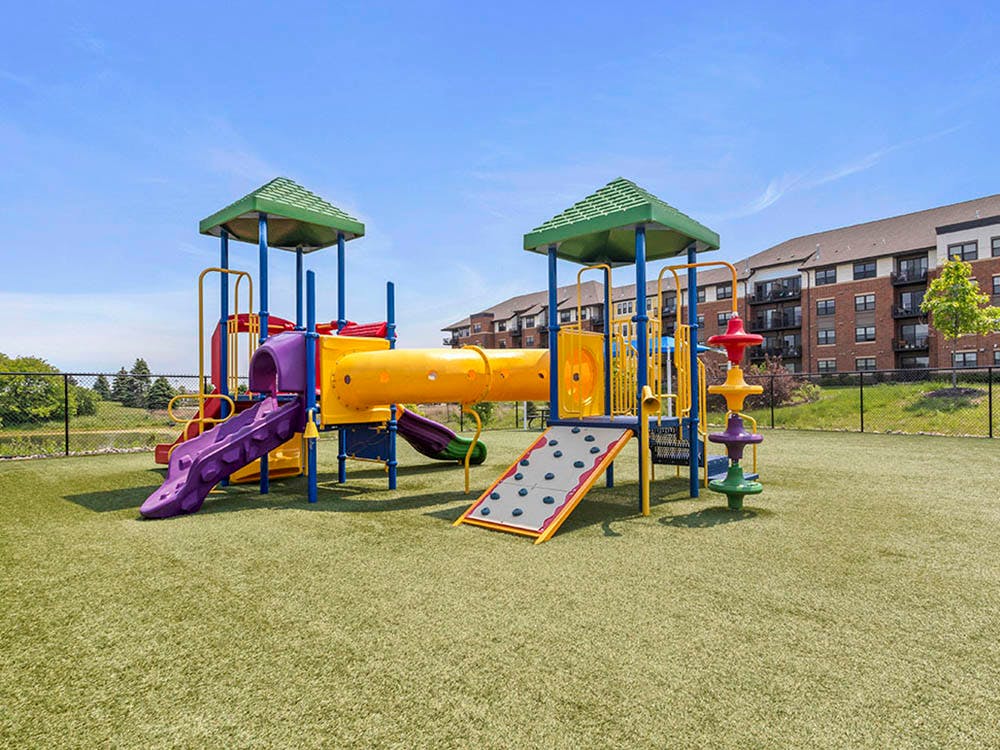 Colorful playground with slides and tunnels on artificial grass