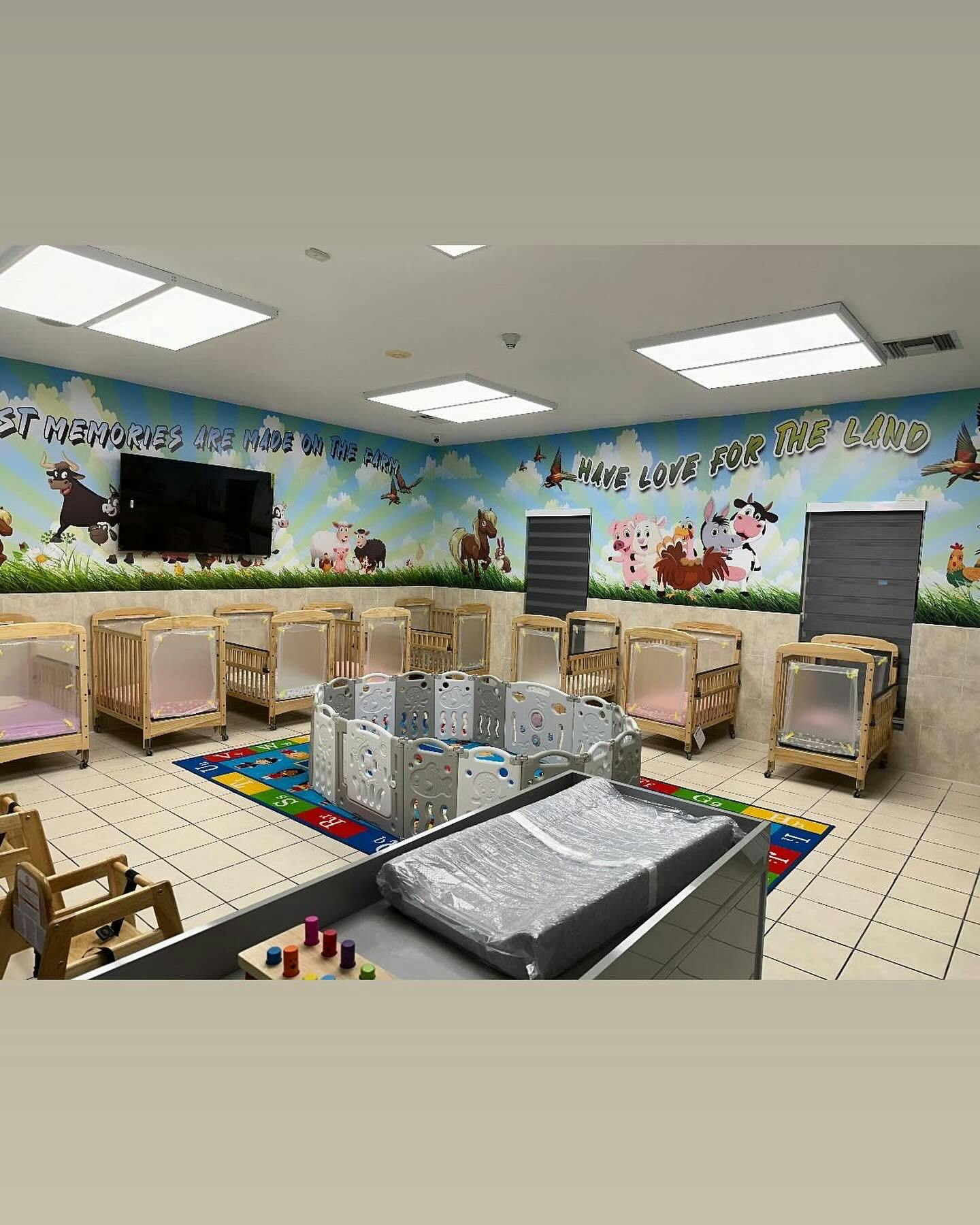 Nursery room with cribs, playpen, and changing table