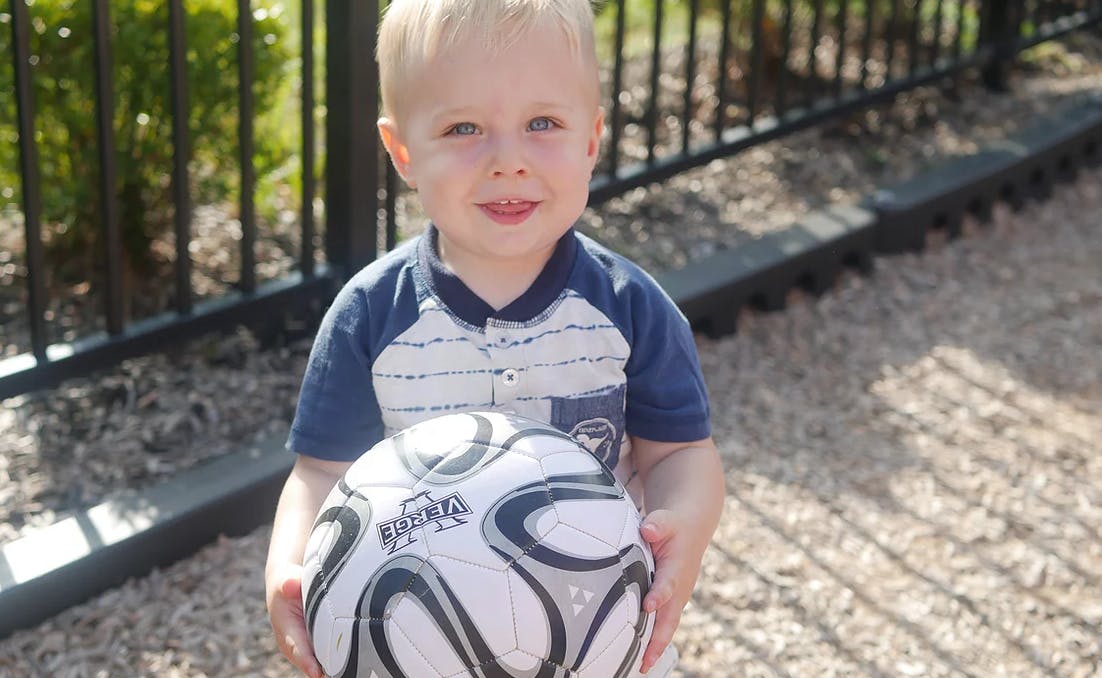Child holding a soccer ball