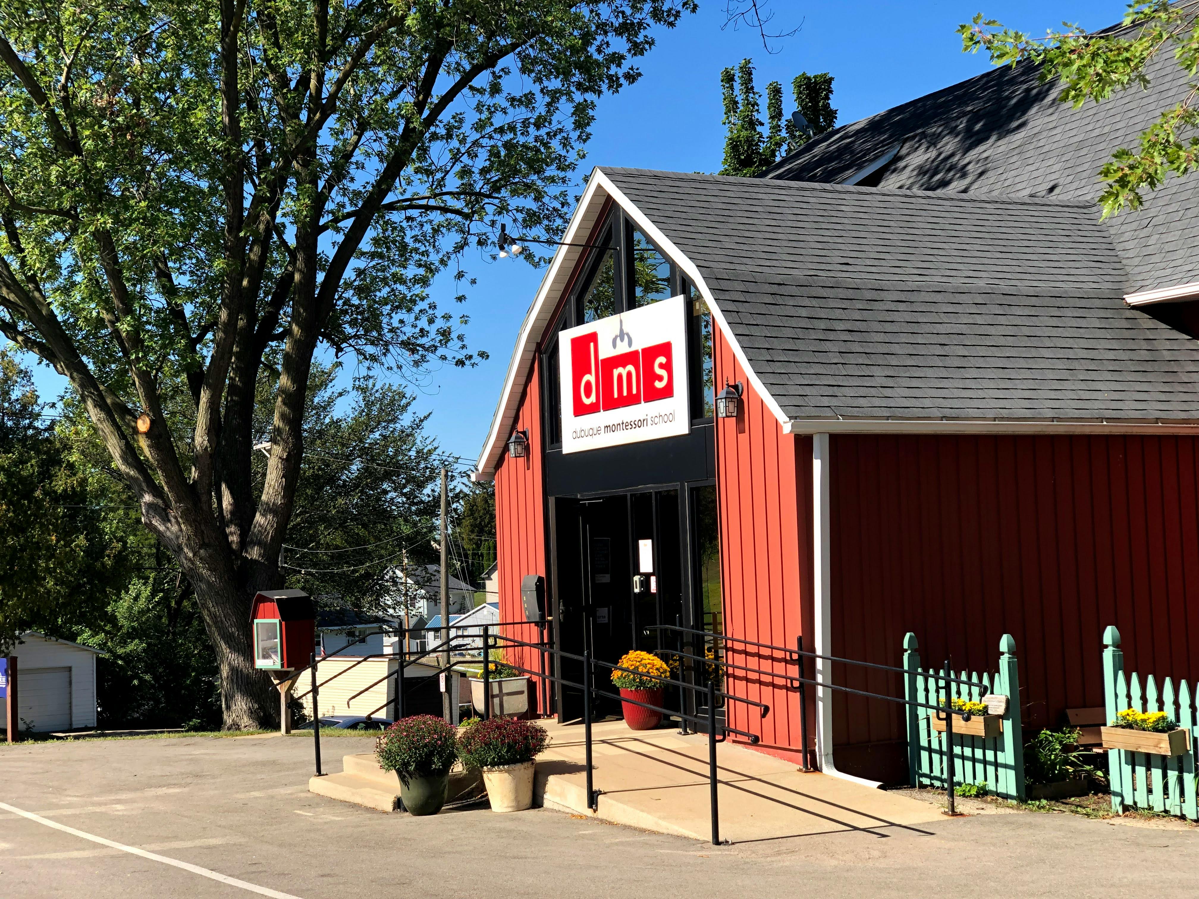 Red barn-style building with a sign that reads "dms"
