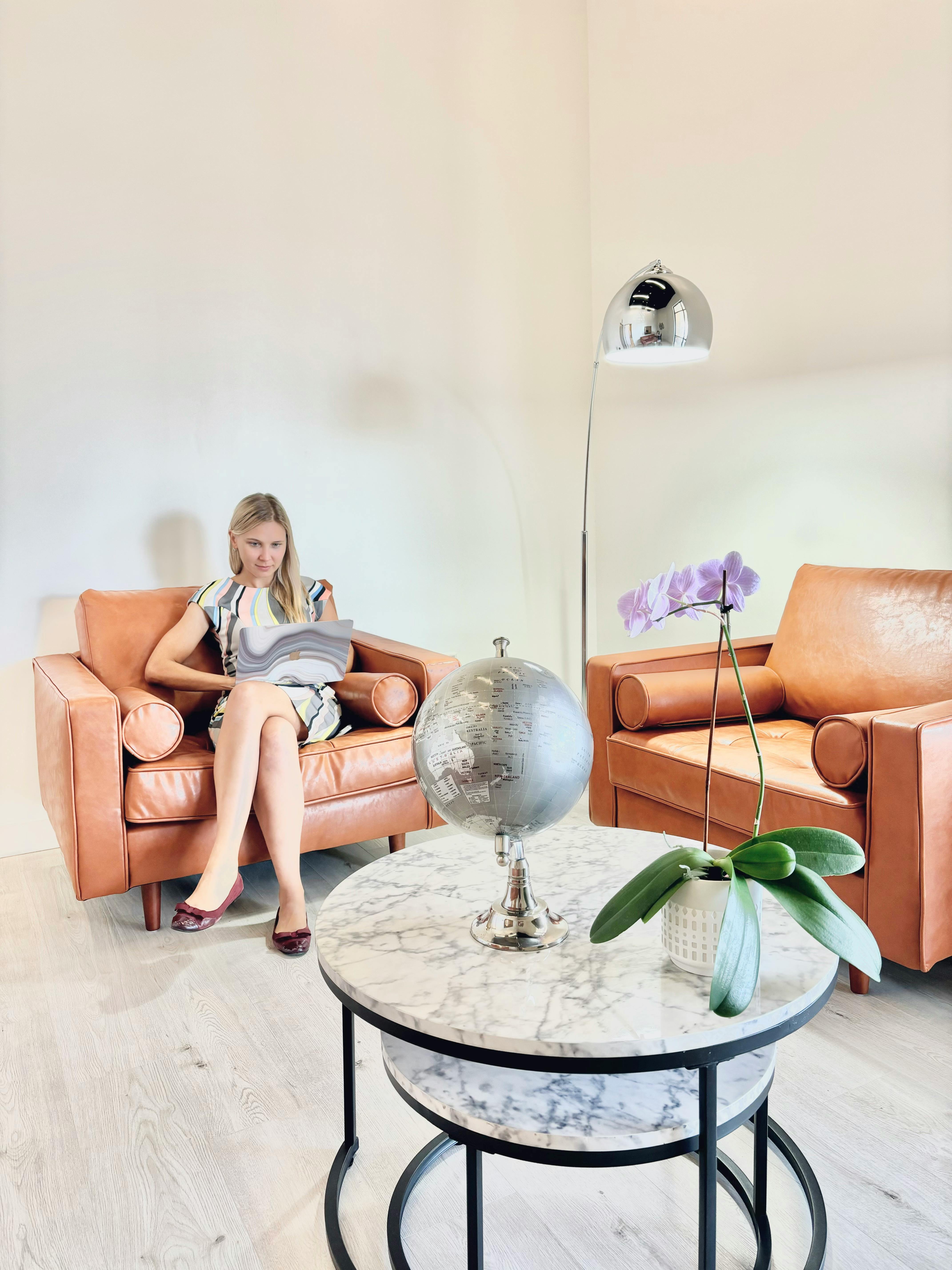 Person sitting in a chair looking at a laptop