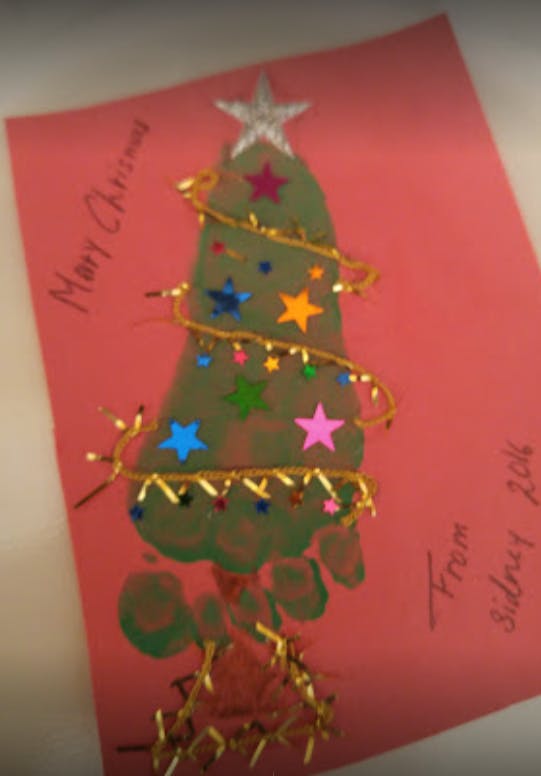 Christmas card with a green footprint decorated as a Christmas tree