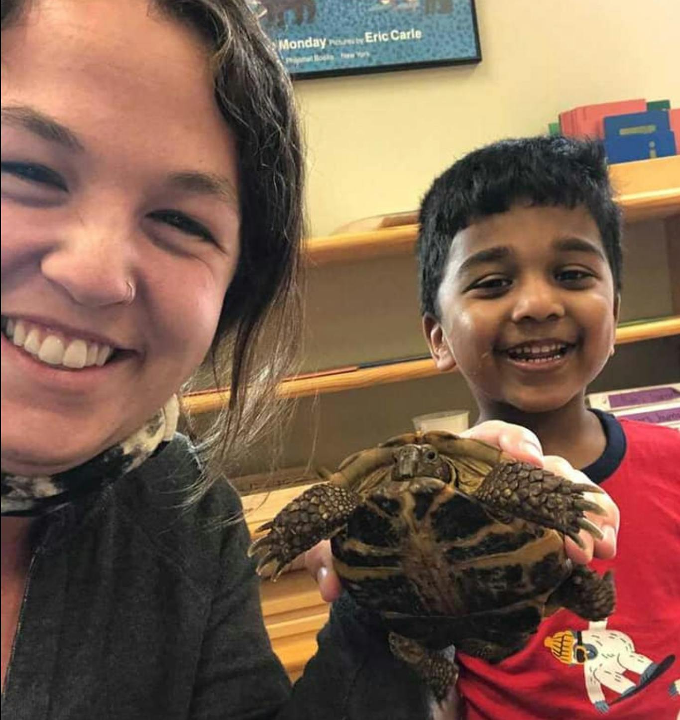 Person and child holding a small turtle