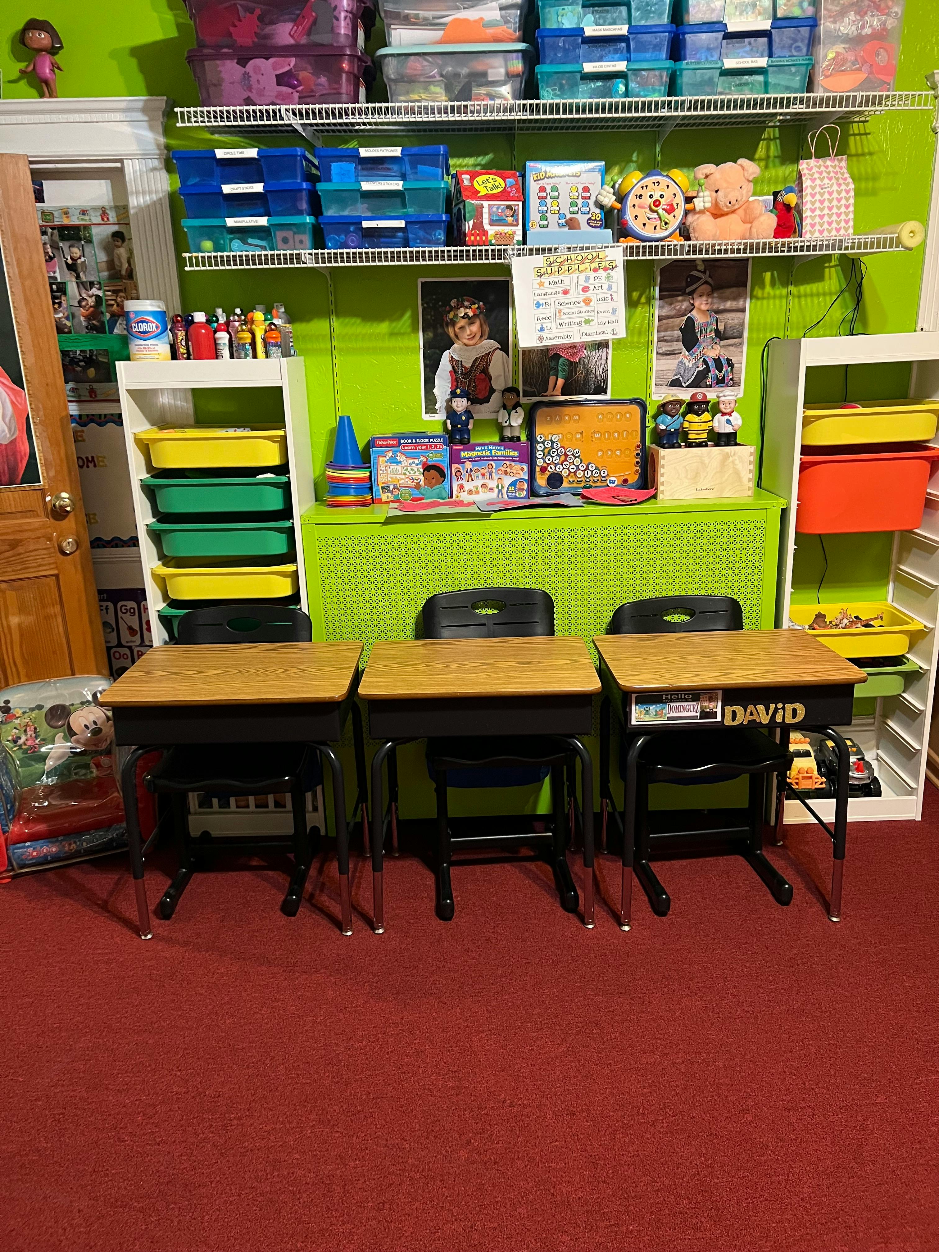 Three student desks and chairs in a classroom