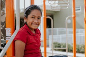 Child in a red shirt on a playground