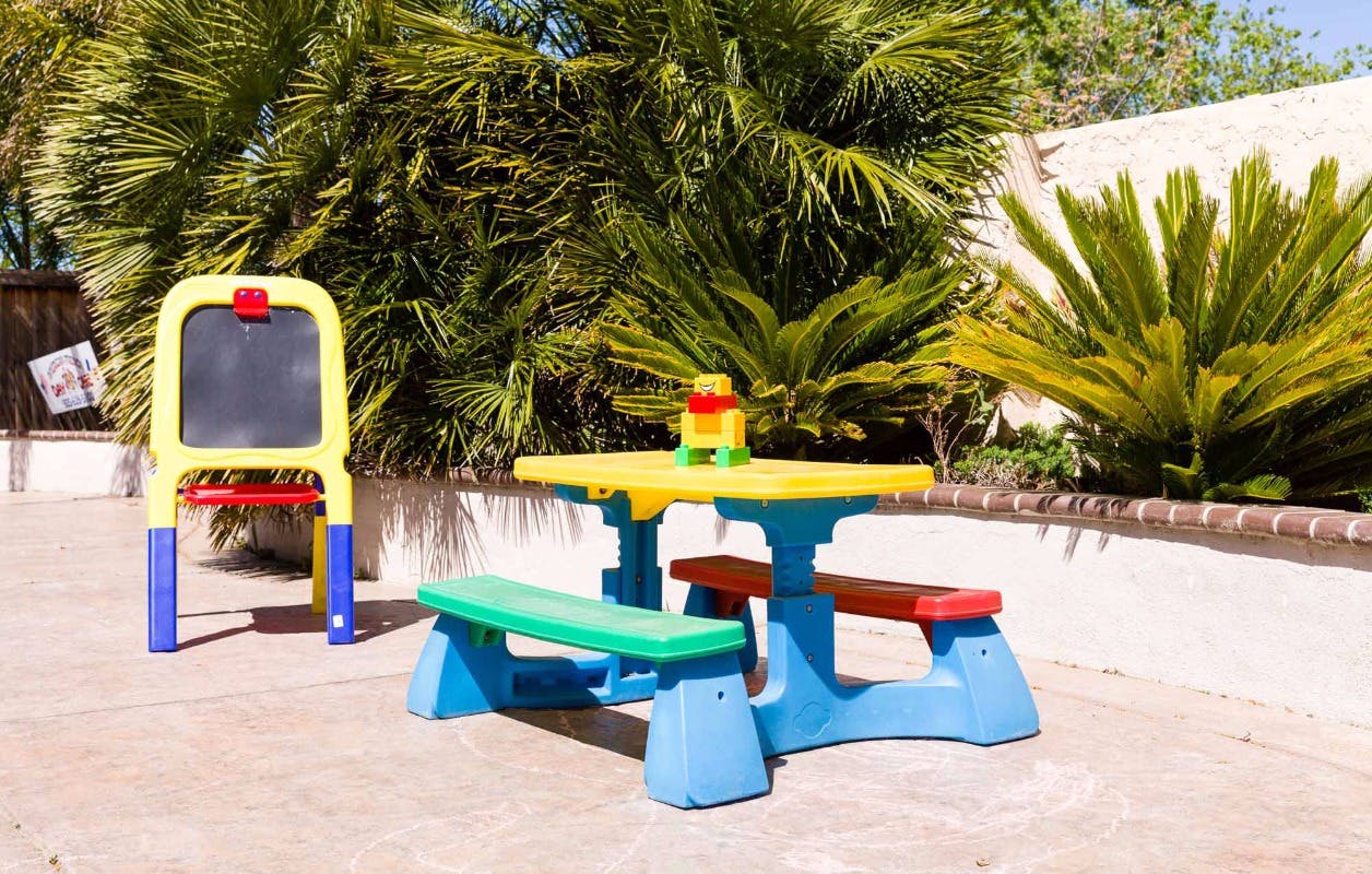 Children's picnic table and easel outdoors
