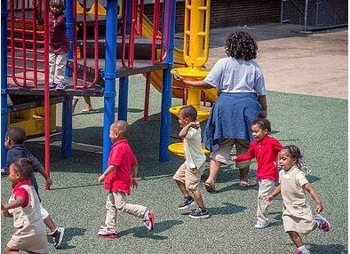 Adult and children on a playground